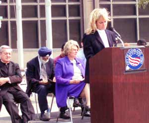 Cathy Panzica speaking with Bishop Pilla, Mayor Jane Campbell and others